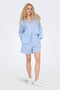 Front image of a model wearing the Augusta shorts in light blue, by brand Only
