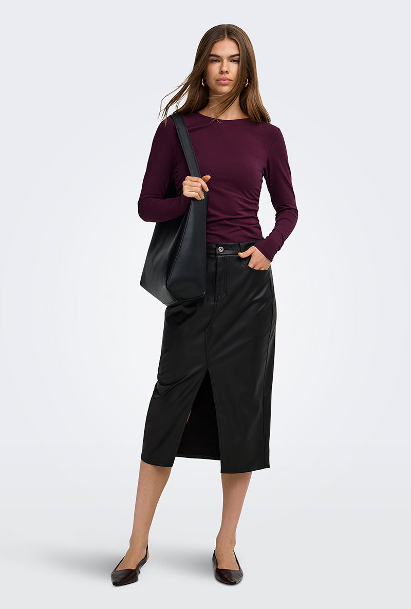 Front image of a model wearing Bitten faux leather pencil skirt in black, by brand Only