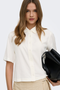 Front image of a model wearing the Goa shortsleeve linen shirt in off white, by brand Only