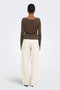 Back image of a model wearing the Hannah l/s metal top in brown, by brand Only