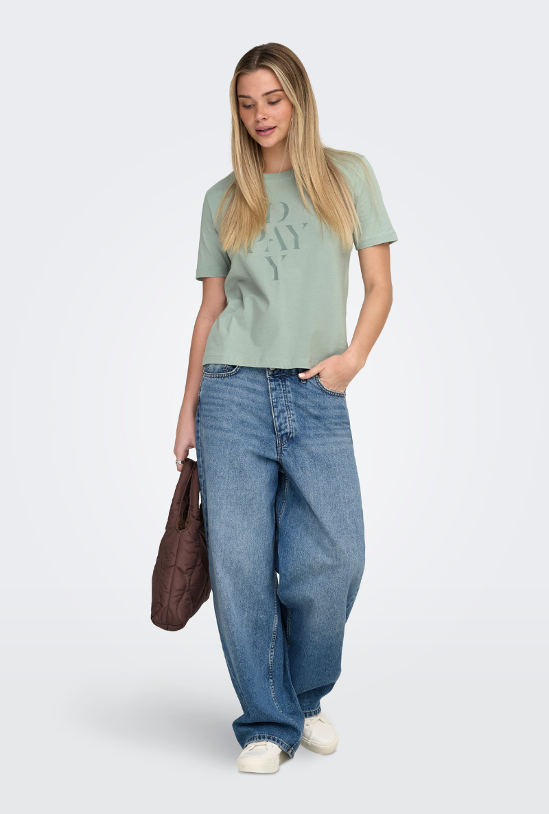Front image of a model wearing Only happy s/s print top in sage, by brand Only