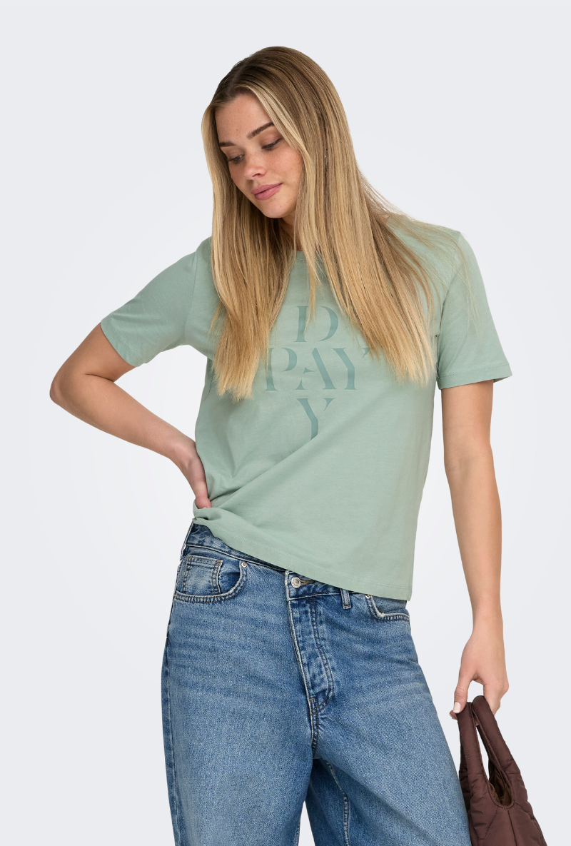 Front image of a model wearing Only happy s/s print top in sage, by brand Only