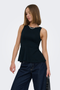 Front image of a model wearing the Kiss sleeveless peplum top in black, by brand Only
