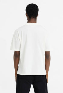 Back image of a model wearing the Initial oversized t in off white, by brand Represent