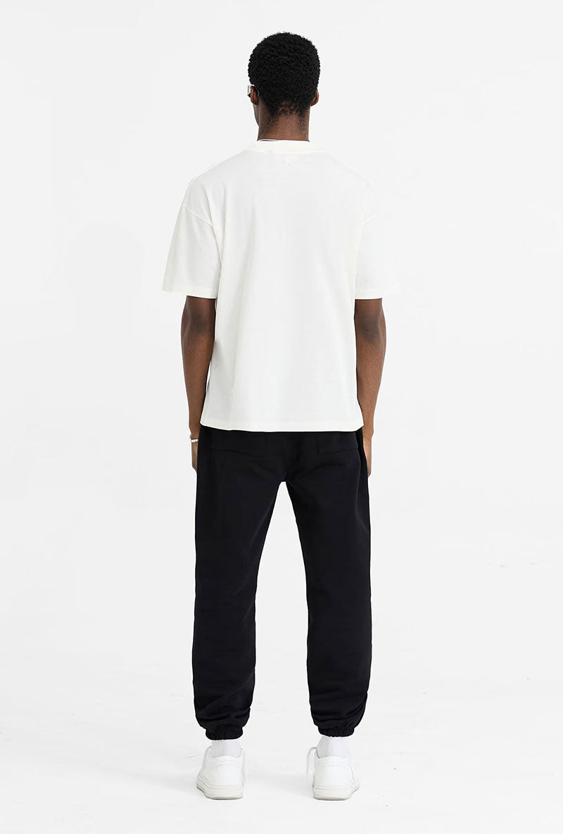 Back image of a model wearing Initial oversized t in off white, by brand Represent