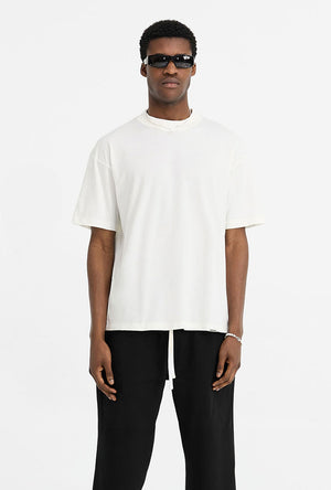 Front image of a model wearing the Initial oversized t in off white, by brand Represent