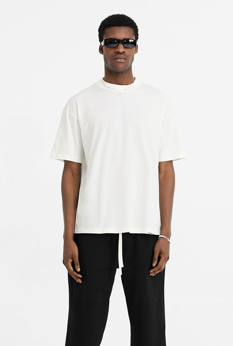 Front image of a model wearing Initial oversized t in off white, by brand Represent