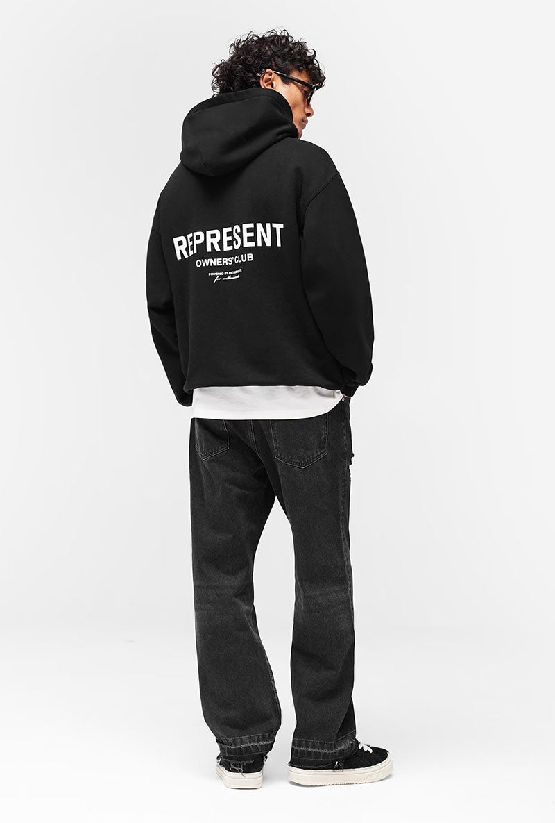 Back image of a model wearing Owners club hoodie in black, by brand Represent