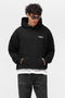 Front image of a model wearing Owners club hoodie in black, by brand Represent