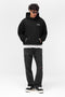 Front image of a model wearing the Owners club hoodie in black, by brand Represent