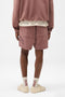 Back image of a model wearing the Owners club script mesh shorts in brown, by brand Represent