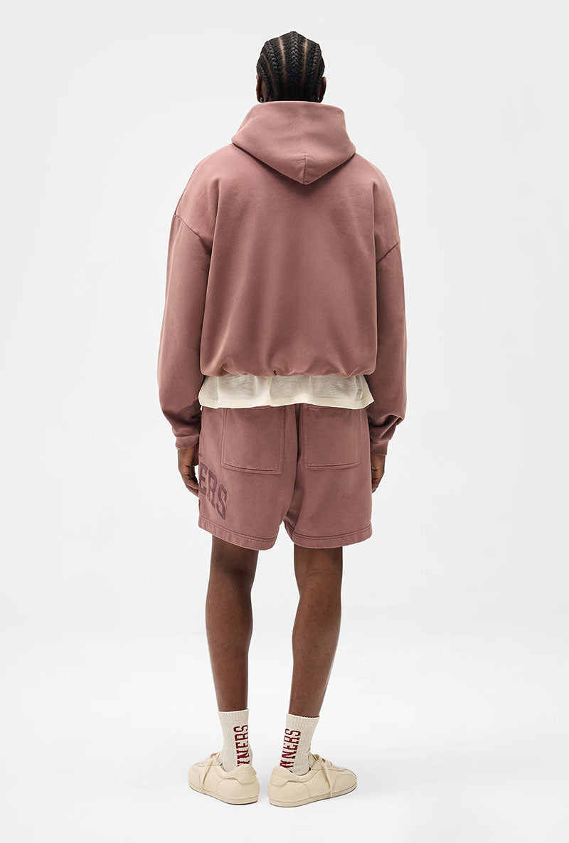 Back image of a model wearing Owners club script mesh shorts in brown, by brand Represent