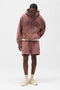 Front image of a model wearing the Owners club script mesh shorts in brown, by brand Represent