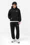 Front image of a model wearing the Owners club sweatpant in black, by brand Represent