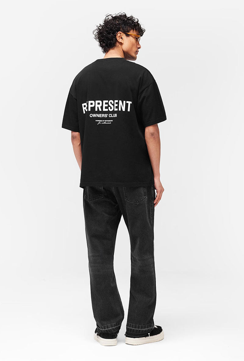 Back image of a model wearing Owners club t in black, by brand Represent