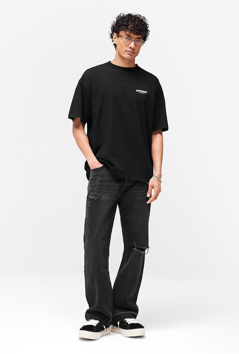 Front image of a model wearing Owners club t in black, by brand Represent