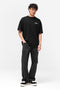 Front image of a model wearing the Owners club t in black, by brand Represent
