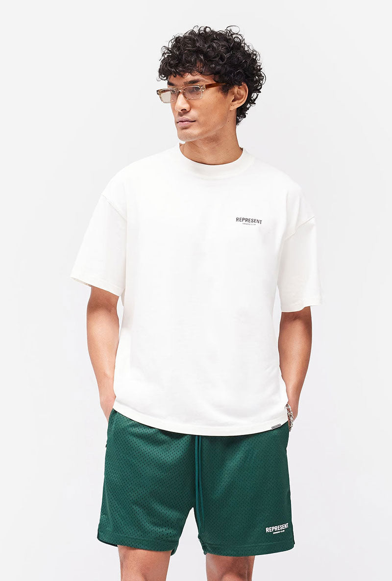 Front image of a model wearing Owners club t in off white, by brand Represent