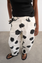 Front image of the Yara highrise dot barrel trousers in white, by brand Top shop