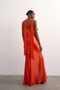 Back image of a model wearing the Annika ruffle maxi dress in rust, by brand Top shop