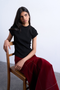 Front image of a model wearing the Bea oneck fitted rib tee in black, by brand Top shop
