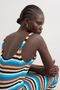 Back detail image of a model wearing the Cajsa sleeveless multi striped knit dress in blue, by brand Top shop