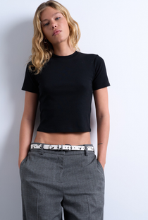 Front image of a model wearing the Everyday crop top in black, by brand Top shop