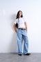 Front image of a model wearing Everyday crop top in white, by brand Top shop