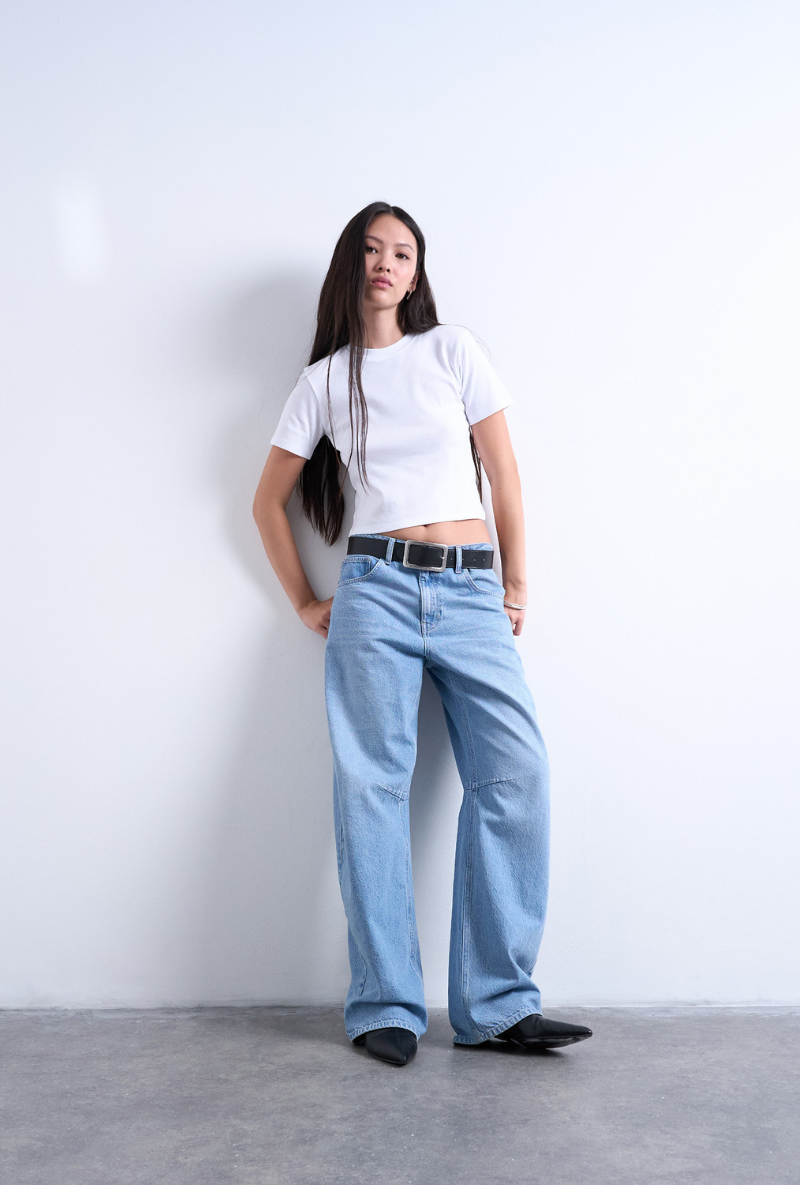 Front image of a model wearing Everyday crop top in white, by brand Top shop
