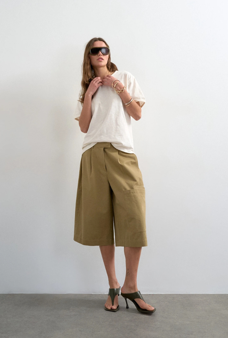 Front image of a model wearing Femke longline cargo shorts in tan, by brand Top shop