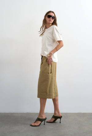 Front image of a model wearing the Femke longline cargo shorts in tan, by brand Top shop