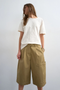 Front image of a model wearing the Femke longline cargo shorts in tan, by brand Top shop