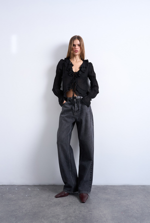 Front image of a model wearing the Fiona ruffle top in black, by brand Top shop
