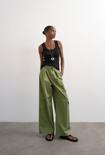Front image of a model wearing the Honey vest in black, by brand Top shop