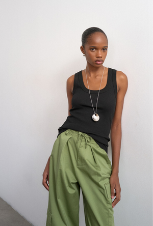 Front image of a model wearing the Honey vest in black, by brand Top shop
