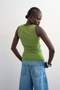 Back image of a model wearing the Honey vest in green, by brand Top shop
