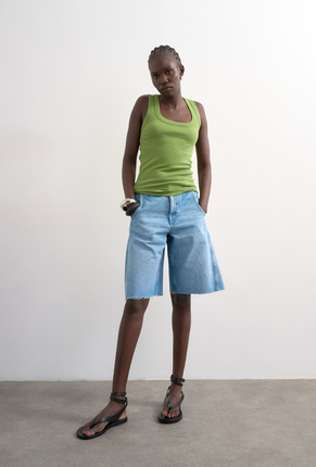 Front image of a model wearing Honey vest in green, by brand Top shop
