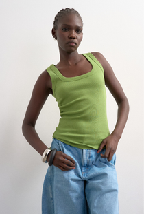 Front image of a model wearing the Honey vest in green, by brand Top shop