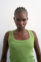 Front image of a model wearing the Honey vest in green, by brand Top shop