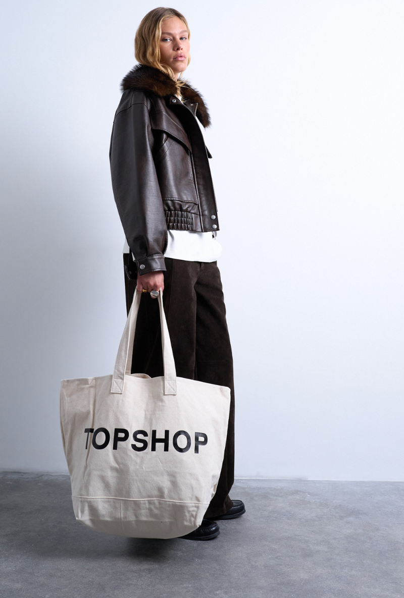 Front image of a model wearing Ivy tote bag in white, by brand Top shop