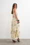 Back image of a model wearing the Mani asymmetric slip skirt in cream, by brand Top shop