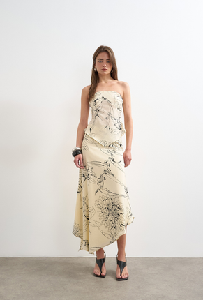 Front image of a model wearing Mani asymmetric slip skirt in cream, by brand Top shop