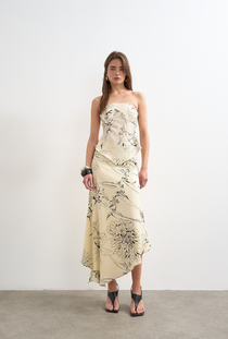 Front image of a model wearing the Mani asymmetric slip skirt in cream, by brand Top shop