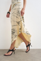 Front detail image of a model wearing the Mani asymmetric slip skirt in cream, by brand Top shop