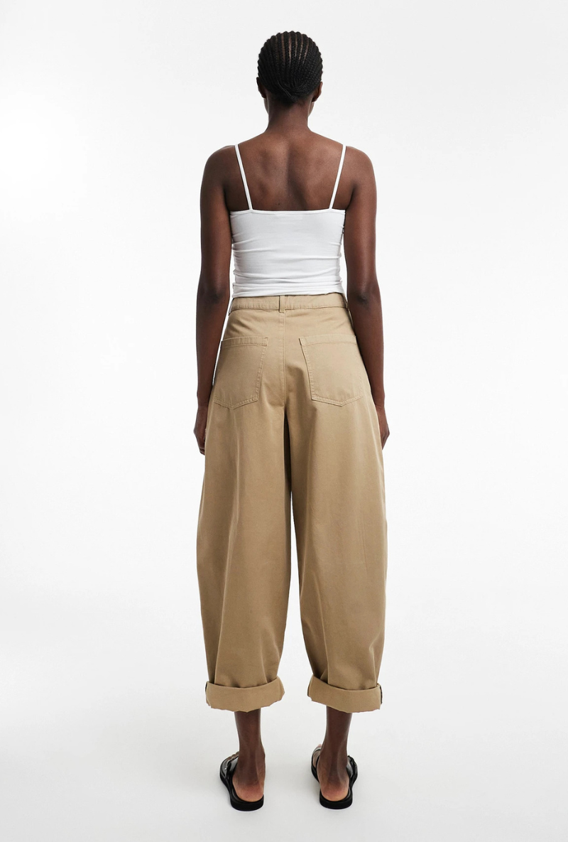 Back image of a model wearing Noor high rise cargo trousers in tan, by brand Top shop