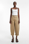 Front image of a model wearing Noor high rise cargo trousers in tan, by brand Top shop