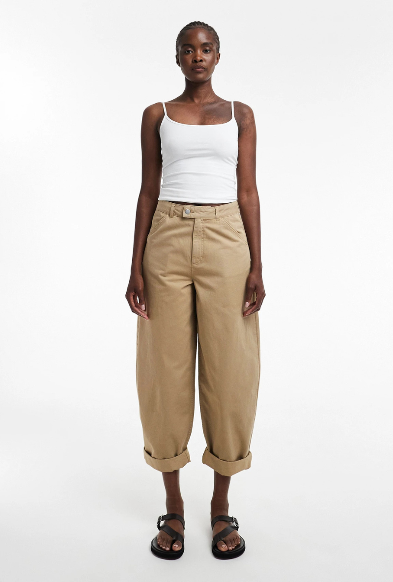 Front image of a model wearing Noor high rise cargo trousers in tan, by brand Top shop