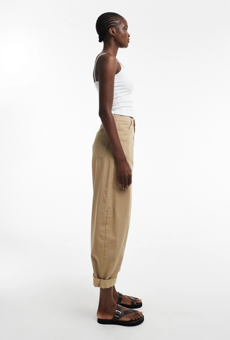 Front side image of a model wearing Noor high rise cargo trousers in tan, by brand Top shop