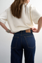 Back detail image of a model wearing the Runway cropped jeans in dark denim, by brand Top shop