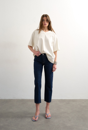 Front image of a model wearing Runway cropped jeans in dark denim, by brand Top shop